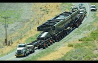 Big trucks hauling oversized load