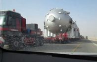 Big trucks hauling oversized load