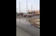 Running truck slips into gear while man is in the store